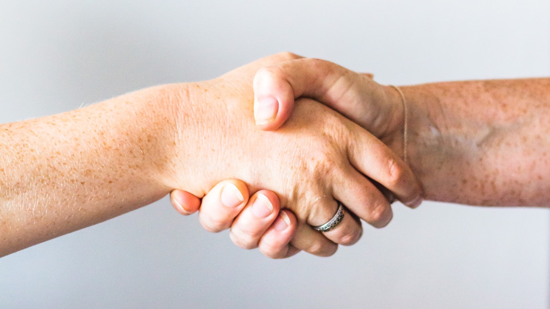 people handshaking because they got a great deal